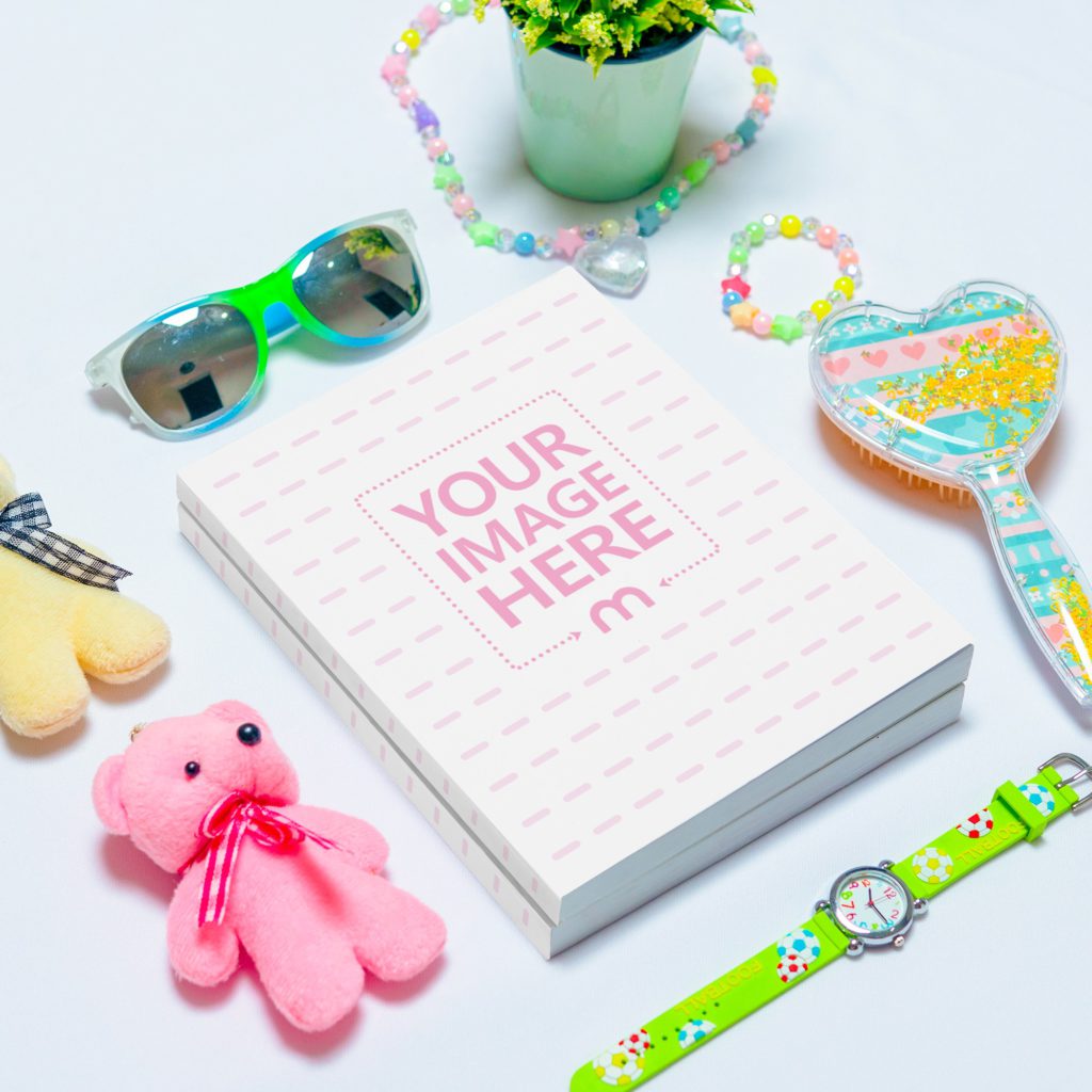 Two books on top, surrounded by a watch, a necklace, a comb, teddy bears and a houseplant.
On a white background.