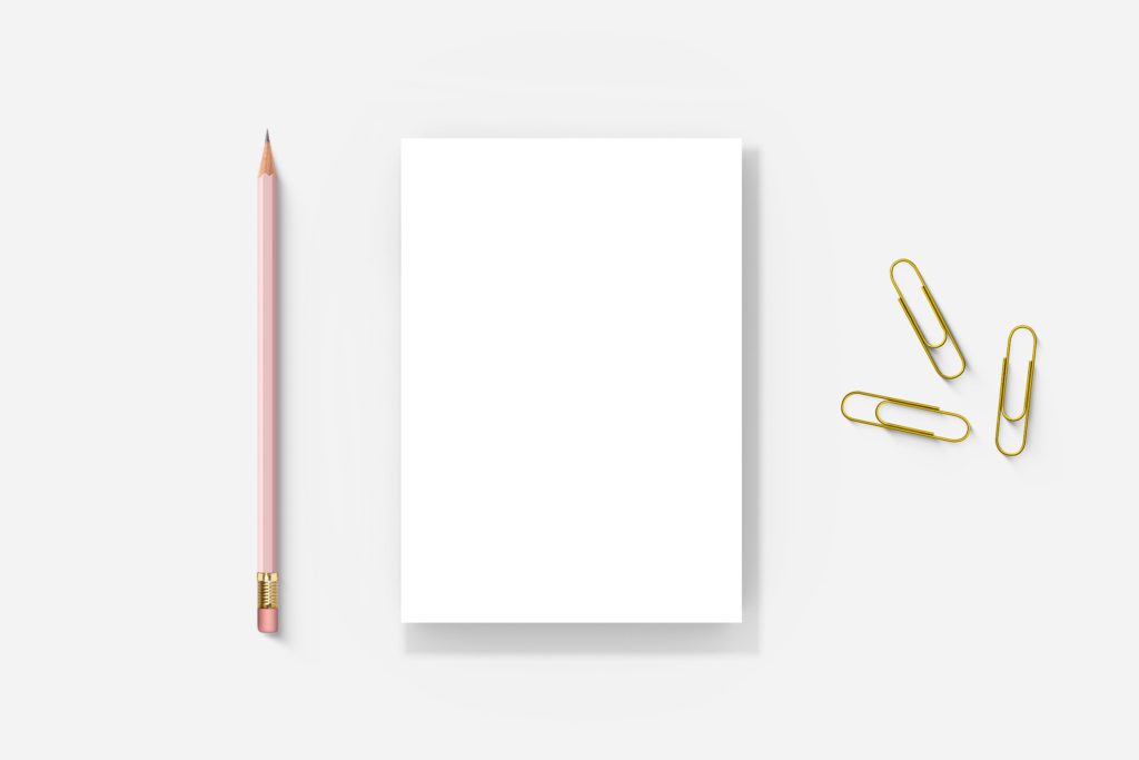 Notepad on a white background with a regular pen and paper clips.