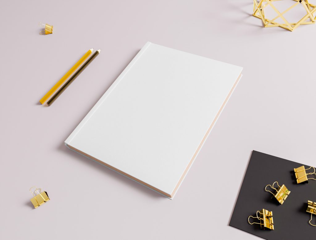 The notebook is on a white table with stationery.